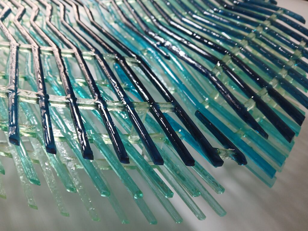 Detail of epoxy resin structure with layered linear elements forming fluid-like patterns